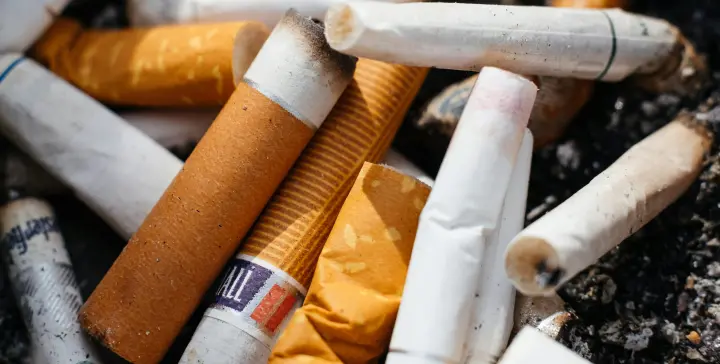 An ashtray full of many cigarette butts.