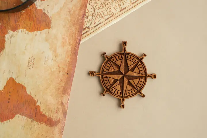 Wind rose on a table with maps of southern hemisphere.