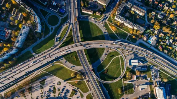Highway interchange and buildings viewed from above.