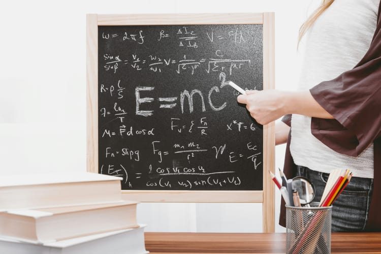 Blackboard containing E equals M C squared and other formulas.