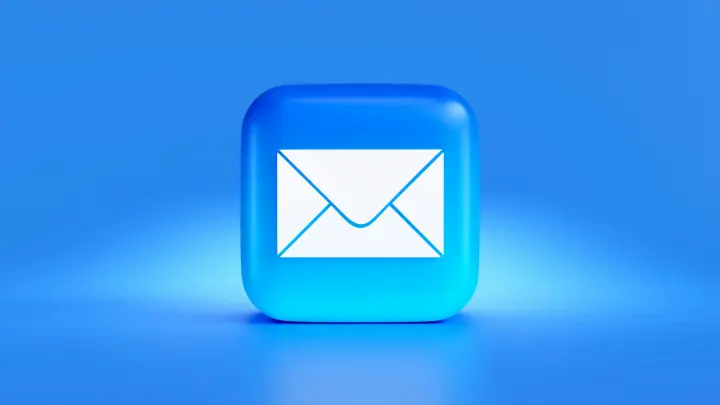 White envelope on a blue button against a blue background.