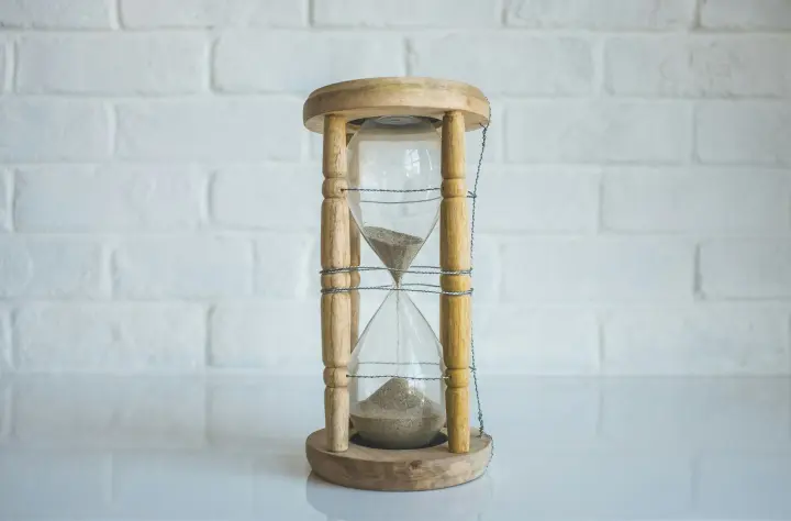 Hourglass with only a quarter of the sand left on top.